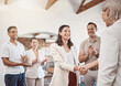 © C Haas/peopleimages.com - Business handshake with clapping workers in the work office. Professional company b2b shaking hands for a deal to come and work together. Diverse group of happy staff thank you and welcome employee
