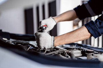 Wall Mural - close up of view Auto mechanic repairman using a socket wrench working engine repair in the garage, change spare part, check the mileage of the car, checking and maintenance service concept.