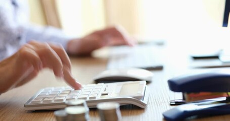 Woman hands typing on the keyboard of computer and digital calculator and preparing electronic payments for bills