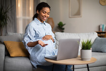 Pregnant African Lady Making Video Call Talking To Laptop Indoor
