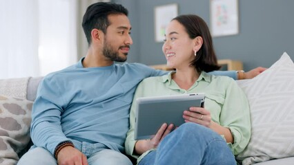 Wall Mural - Asian couple, tablet and talking while doing online shopping, research or browsing social media to relax on couch at home. Enjoying internet entertainment with mobile app during weekend or free time