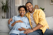 © Prostock-studio - Happy African American Young Couple Embracing Smiling To Camera Indoor