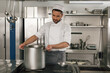 © Friends Stock - Chef cooking tasty dish in kitchen of restaurant using modern equipment