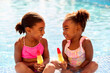 © Monkey Business - Family On Summer Holiday With Two Girls Eating Ice Lollies By Swimming Pool