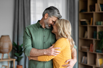 Mature Romance. Portrait Of Romantic Middle Aged Spouses Bonding At Home