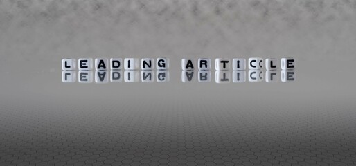 Wall Mural - leading article word or concept represented by black and white letter cubes on a grey horizon background stretching to infinity