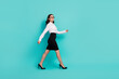 © deagreez - Full body profile portrait of pretty successful lady walking isolated on turquoise color background