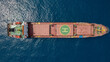 Large Red Cargo ship at sea with a Helipad