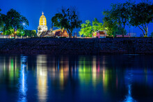 Light On The Nan River And Chedi Of Prang Wat Phra Si Rattana Mahathat Also Colloquially At The Nan River And The Park At Night In Phitsanulok, Thailand.