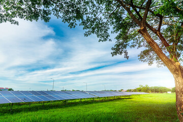 Wall Mural - Photovoltaic solar power panel on dramatic sunset blue sky background, green clean Alternative power energy concept.