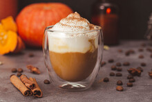 A Glass Of Autumn Pumpkin Latte With Whipped Cream And Spices. Coffee With Pumpkin And Cinnamon On A Dark Background