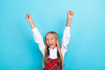 Wall Mural - Photo of young smart cute pretty little schoolkid girl fists up winner hooray excited positive isolated on blue color background