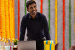 © IndiaPix - Young man smiling while working in office during Diwali celebration