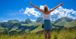 happy woman hiker enjoying panoramic view of mountain