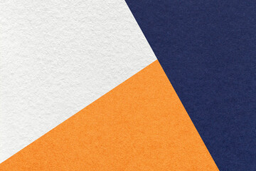 Wall Mural - Texture of craft navy blue, white and orange shade color paper background, macro. Vintage abstract indigo cardboard
