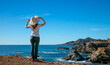 woman looking at seacoast and blue sky