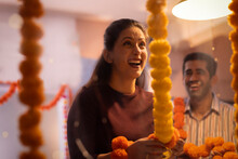 Female Employee Decorating Office On The Occasion Of Diwali