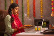 © IndiaPix - Female employee praying to Godduring Diwali celebration