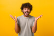 © Vadim Pastuh - Astonished Indian young curly man screams wow and looking at the camera with mouth wide opened, surprised happy guy excited with incredible promotion, standing isolated on yellow