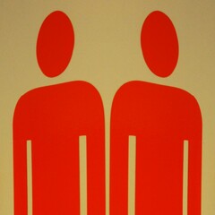 Wall Mural - symbol of two male outlines in red upon a beige background