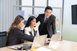 © SKW - A group of young Asian businessmen Talking and planning work happily and have fun. at the company's office