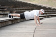 © Renata Hamuda - Elderly male retiree is doing push ups exercise outdoor. Stay active in retirement