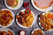 © ADDICTIVE STOCK - Different fast food dishes on table