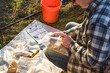Agriculturist preparing soil samples to laboratory analysis, marking sample bags outdoors at sunrise. Farmer performing soil sampling at agricultural field. Environment research, soil certification