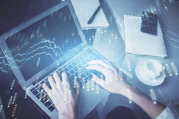 Double exposure of woman hands typing on computer and forex chart hologram drawing. Stock market invest concept.