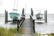 © Ursula Page - A small wood boat dock pier with two boats raised