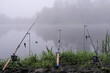 Misty foggy river and three fishing rods