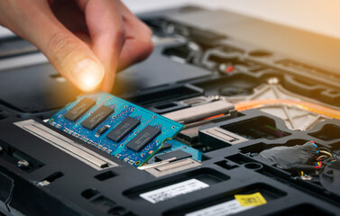 engineer install new RAM (Random-access memory) to memory slot on laptop motherboard.                           