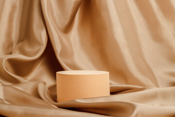 Geometric podium with golden silk smooth textile background. Display for cosmetic and product presentation