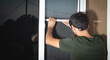 © andranik123 - Man installing the mosquito net on the window.