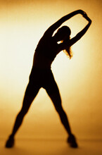 Silhouette Of A Woman Exercising