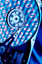 Close-up Of A Hard Drive With Binary Code Superimposed Over It