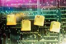 Close-up Of Key Spelling HTML On A Circuit Board
