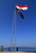 The National Flag Of Croatia Displayed On The Mast By The Pirate Tavern In The Port

