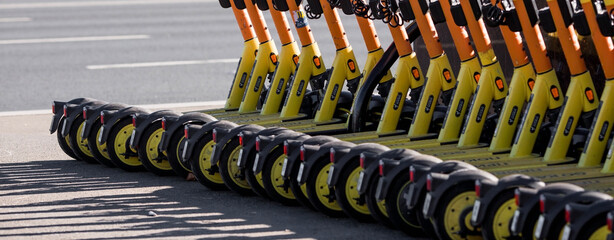 Urban transport. Parking for electric scooters and scooters. Minute-by-minute scooter rental in the city. There are many scooters in a row. Moscow, Russia, September 2022