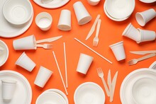 Disposable Tableware On Orange Background, Flat Lay