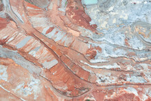 Aerial View Of The Quarry, Beautiful Orange Patterns And Overhanging Rocks In A Copper-magnesium Quarry