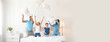 © New Africa - Happy family playing with pillows in bedroom, space for text. Banner design