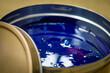 A can of blue polygraph offset paint for the printing press. Special UV ink for printing. Cyan color. Open new can of blue paint. Selective focus