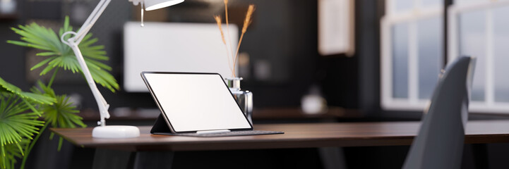 Canvas Print - modern office workplace with digital tablet mockup and copy space on dark wood tabletop.