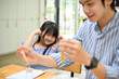 © bongkarn - Lovely young Asian girl covering her ears while her teacher doing an exciting chemical experiment