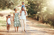 © David Lahoud/peopleimages.com - Happy black family bonding on an outdoor work in a park, loving and having fun together. African American parents enjoying fresh air and an active walk with their children, playful, cheerful and free