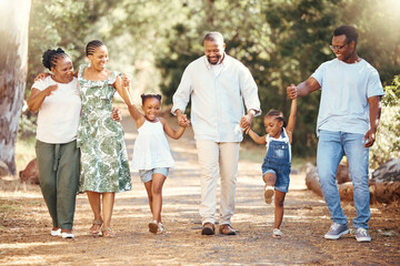 Black family, hiking or bond with children, parents or grandparents walking in remote nature forest and countryside. Happy mother, father or senior holding hands with girls and skipping in tree park