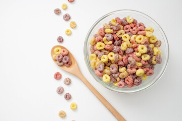 Wall Mural - Healthy food concept, Colorful ring cereals in bowl with cereals in spoon and falling on the floor