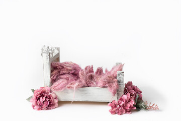 Pink fluff with pink flowers around bed that has crown hanging on post set scene for layer newborn photography composite background for little princess baby girl