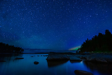 Wall Mural - night landscape with a starry sky and milky way with many bright stars. astrophotography with conste